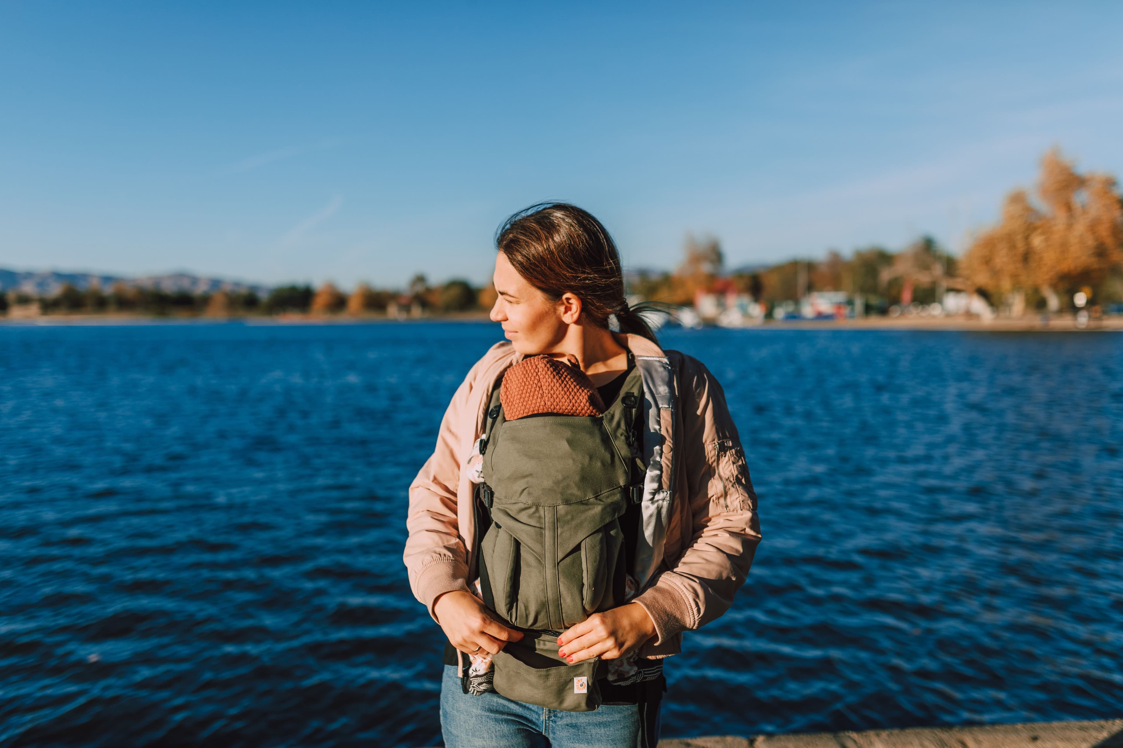 Parent wearing a baby in an ergonomic carrier — BabyCosts Australia