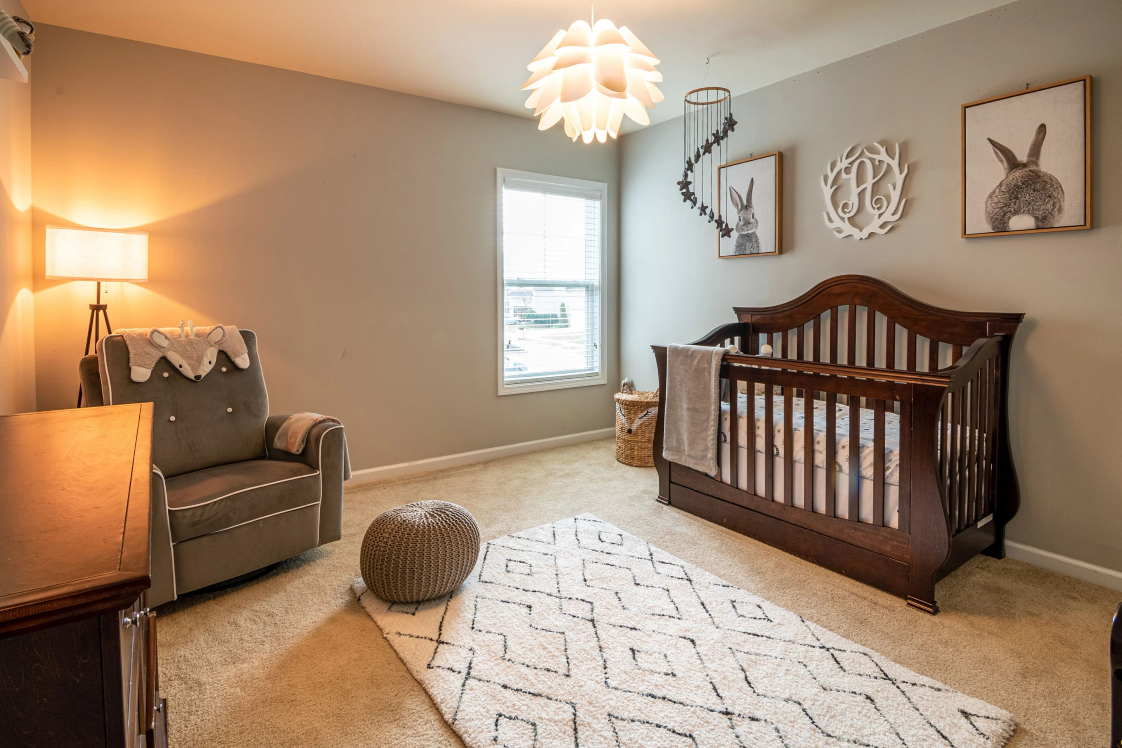 Father gently placing his baby into a wooden nursery crib — BabyCosts Australia