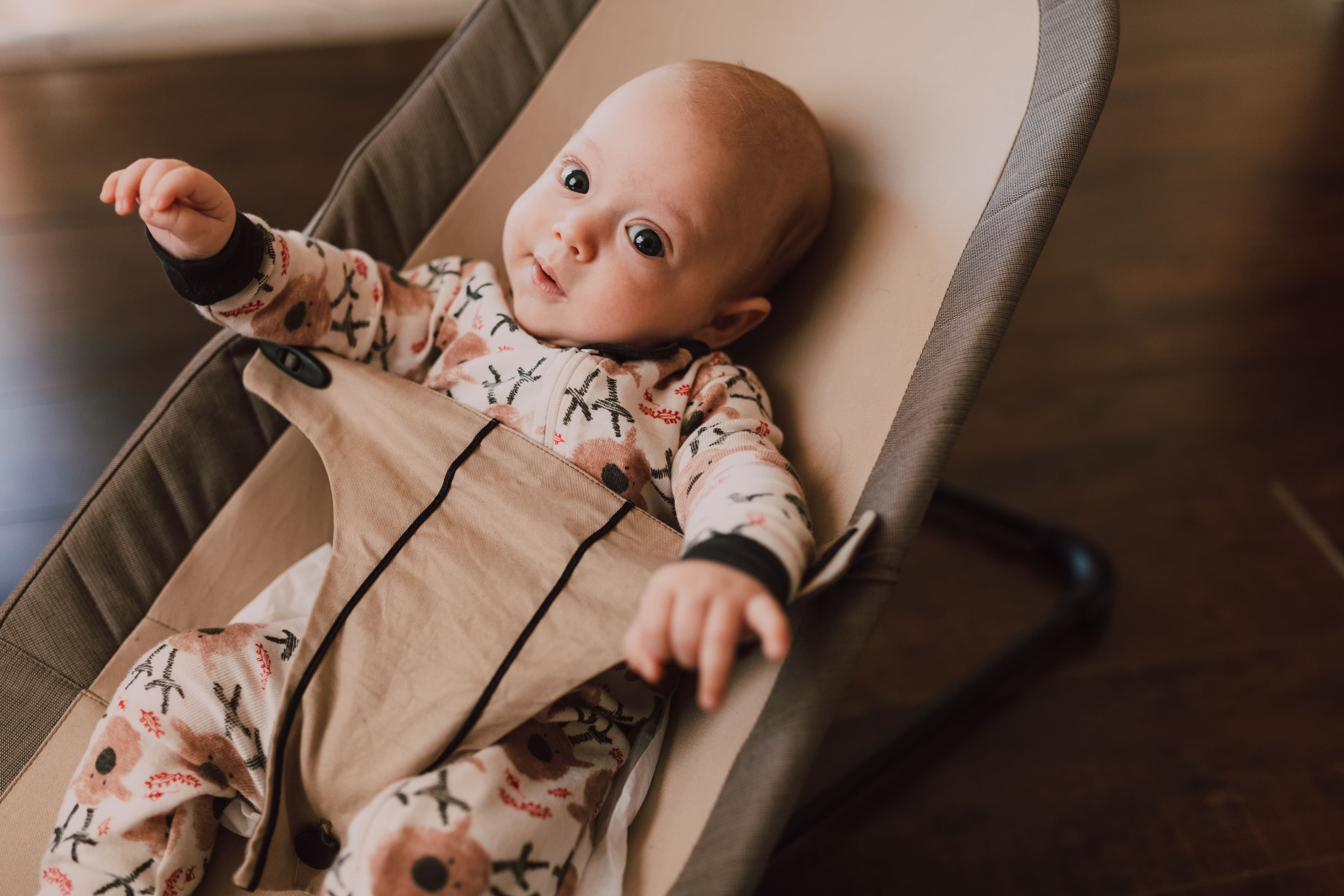 Soft plush teddy bear hanging from a baby nursery mobile — BabyCosts Australia