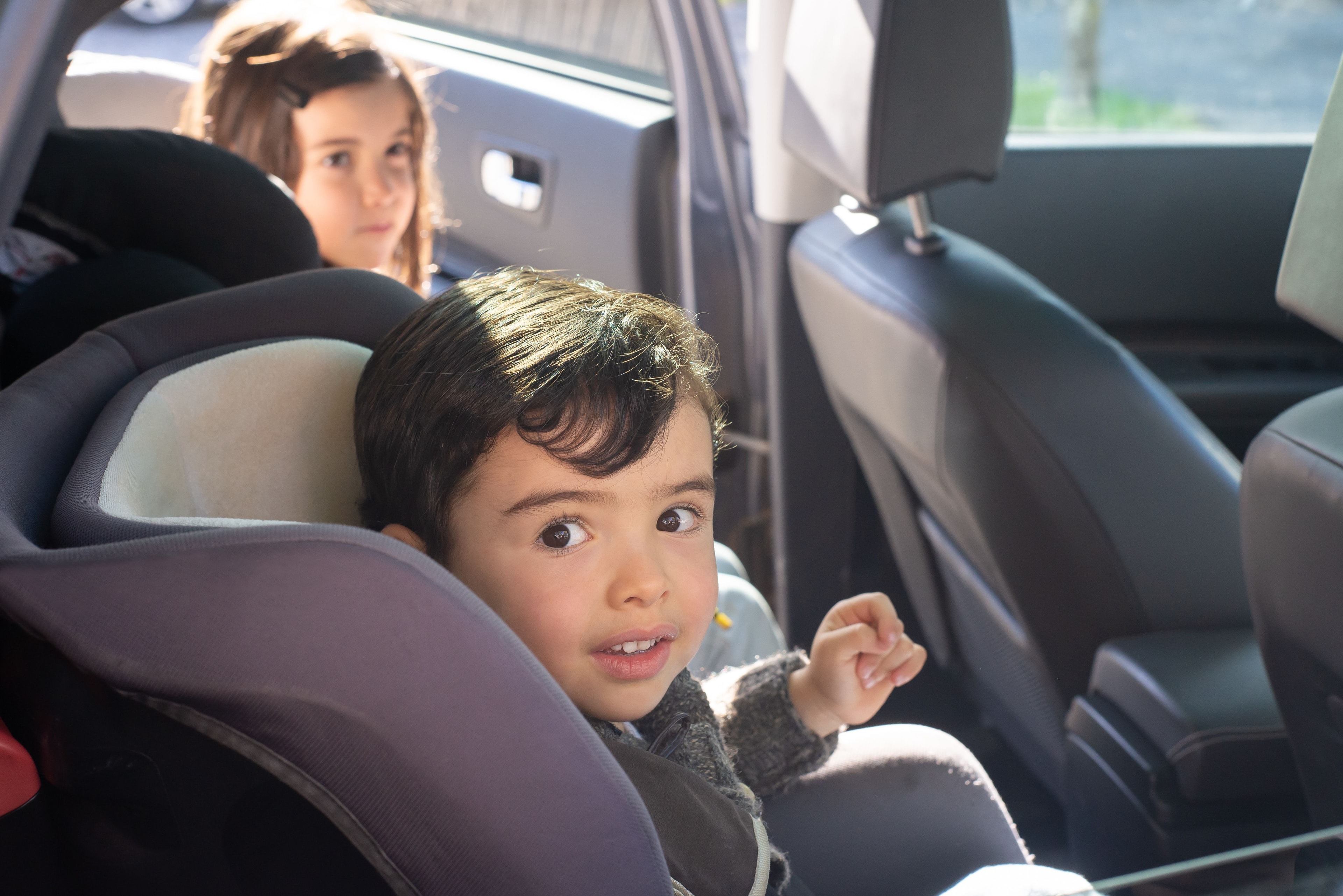 Young child sitting safely in a car seat inside a vehicle