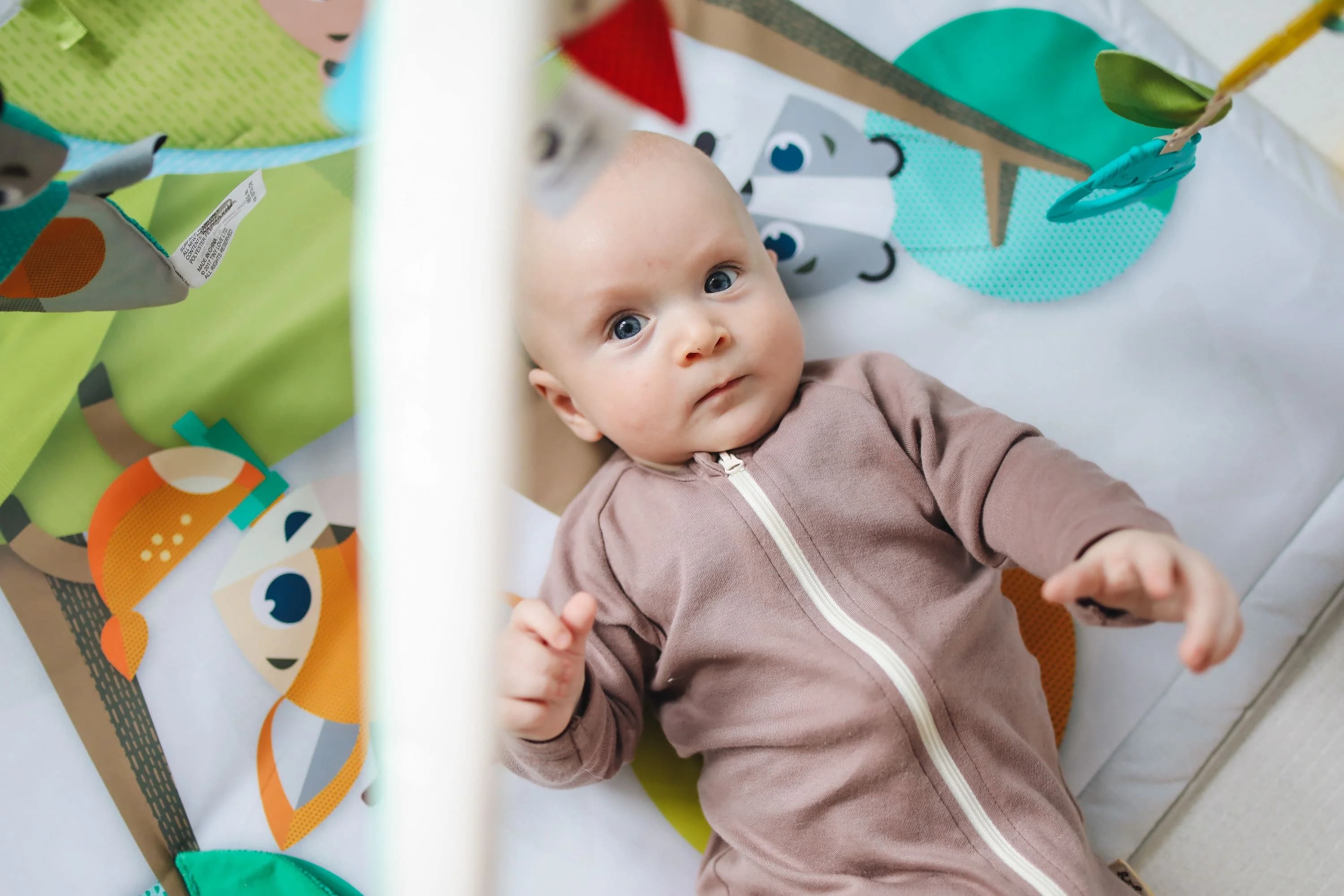 Soft plush teddy bear hanging from a baby nursery mobile — BabyCosts Australia