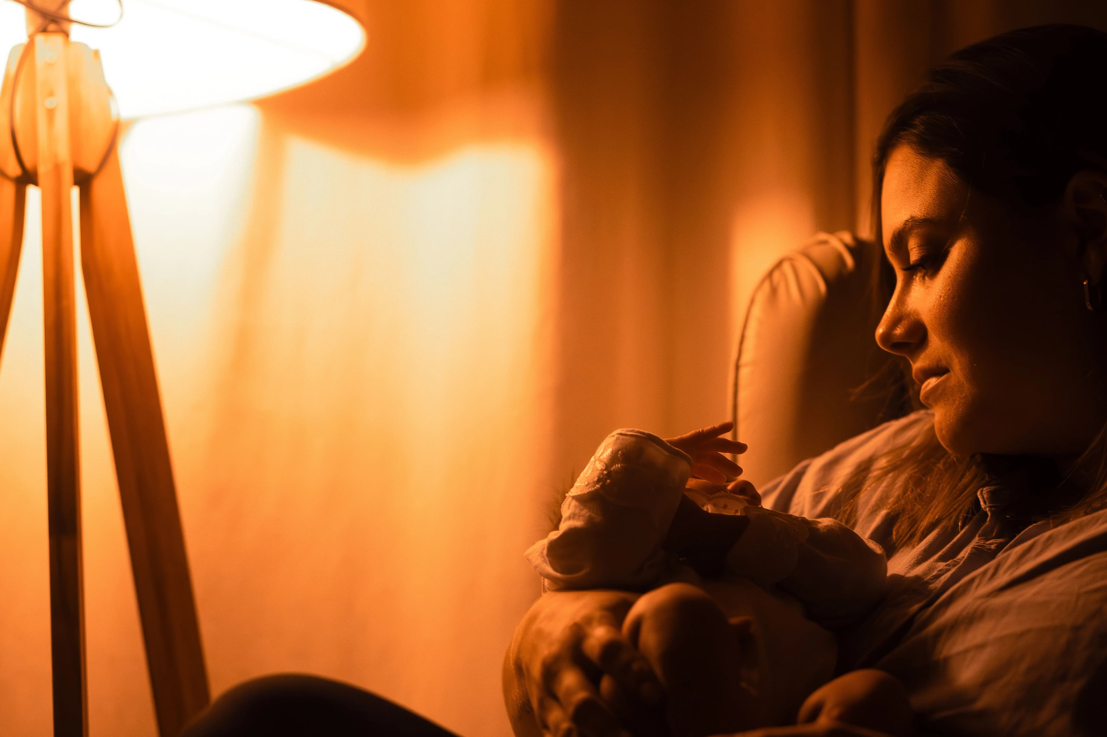 Father gently placing his baby into a wooden nursery crib — BabyCosts Australia